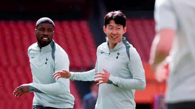 Tottenham players smile during training session