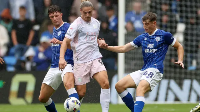 Will Fish (left) and Dylan Lawlor (right) attempt to tackle a Plymouth Argyle player