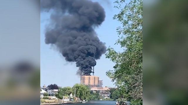 A fire at a building in Staines seen from the river