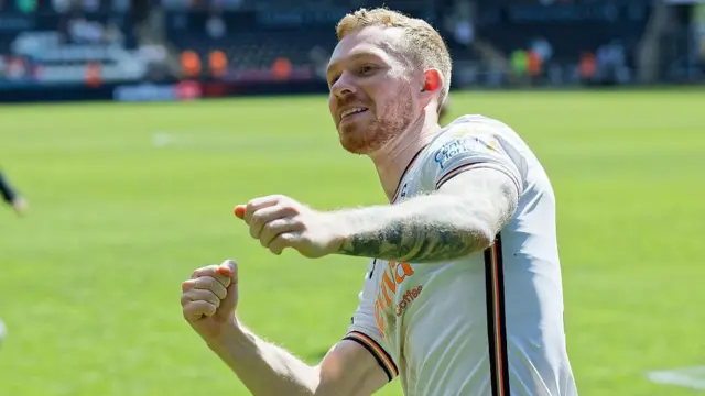 Lewis O'Brien celebrates with Swansea fans on the final day of the season