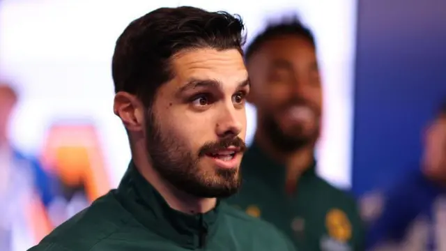 Pedro Neto arrives at a stadium