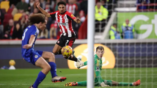 Kevin Schade of Brentford scores his team's third goal as Mads Hermansen of Leicester City fails to make a save and Wout Faes of Leicester City fails to block the shot during the Premier League match between Brentford FC and Leicester City FC at Gtech Community Stadium