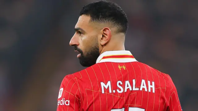 Back of Mohamed Salah while he looks on during match