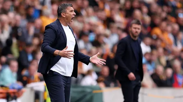 Sergej Jakirovic shouts from the touchline as Michael Carrick looks on