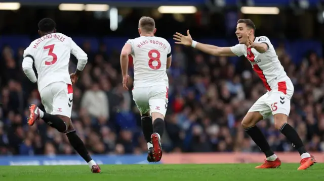 James Ward-Prowse celebrates after scoring Southampton's first goal against Chelsea from a free-kick with team-mates Ainsley Maitland-Niles and Romain Perraud