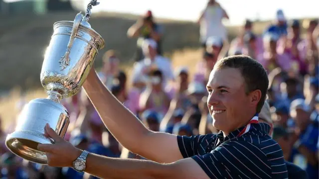 Jordan Spieth holds up his trophy