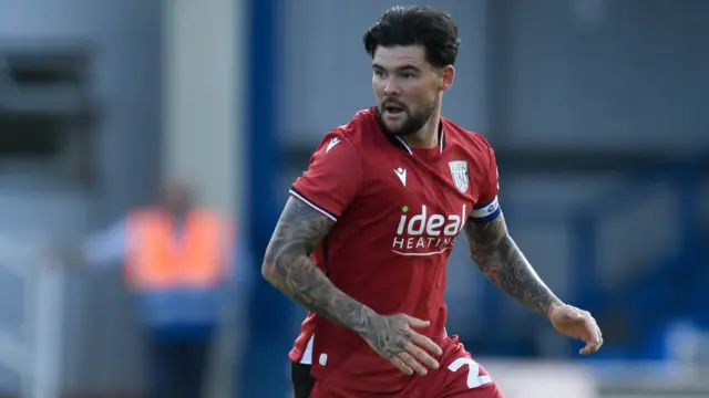 Alex Mowatt wearing a red kit in action for West Bromwich Albion