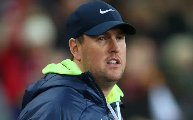 Sunderland interim head coach Mike Dodds in a blue nike cap and blue jacket with green hood