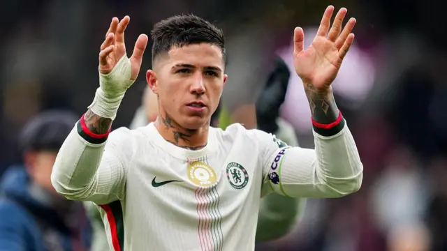 Chelsea's Enzo Fernandez holding his hands in the air during a Chelsea away game