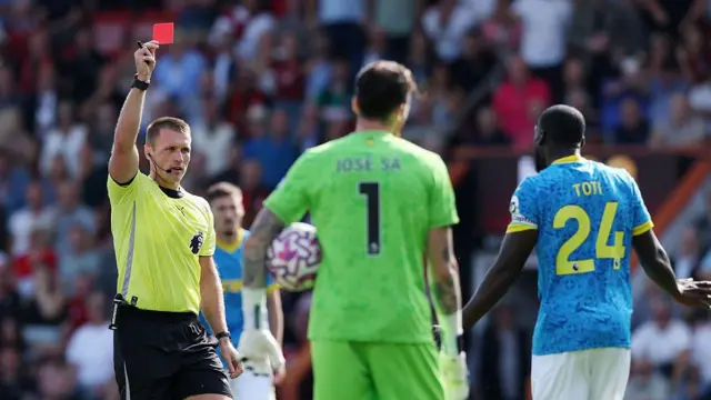 Referee Thomas Bramall shows a red card to Toti