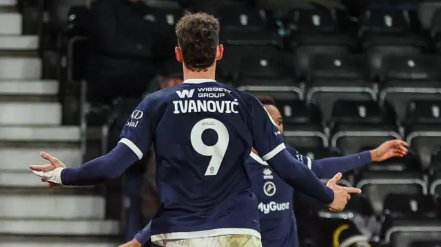 Millwall's Mihailo Ivanovic facing away from the camera in his home shirt