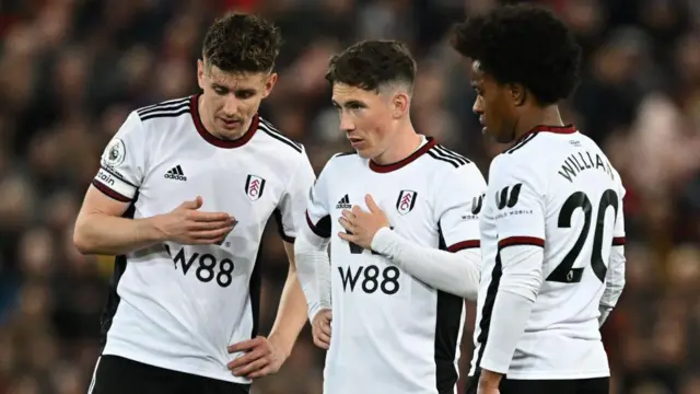 Tom Cairney, Harry Wilson and Willian stand over a free-kick for Fulham