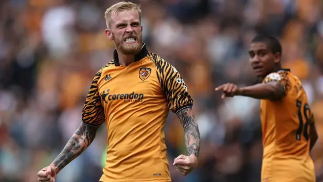 Ollie McBurnie celebrates with fists clenched after scoring the winner for Hull City
