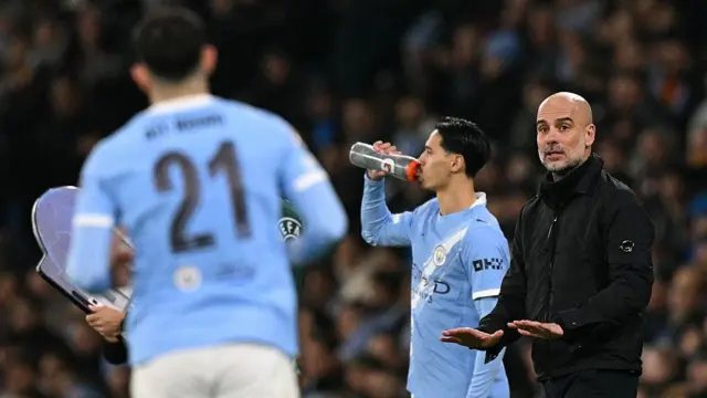 Pep Guardiola gestures to calm down