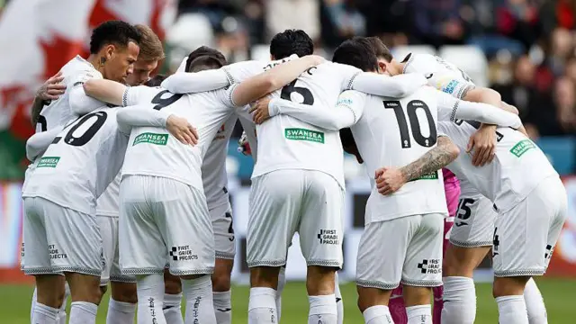 Swansea players in a huddle 