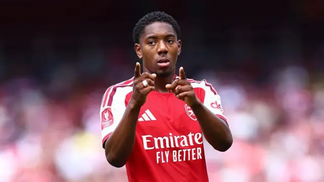 Myles Lewis-Skelly of Arsenal points at the camera