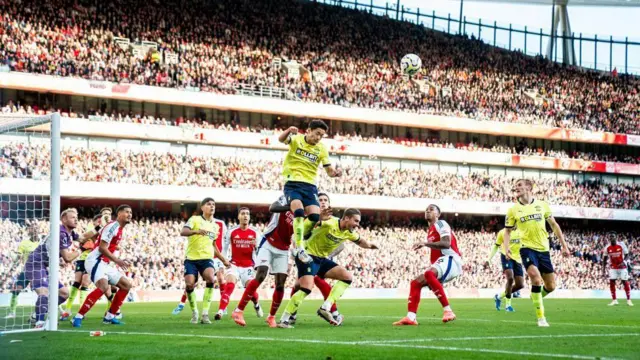 Yukinari Sugawara heads the ball away