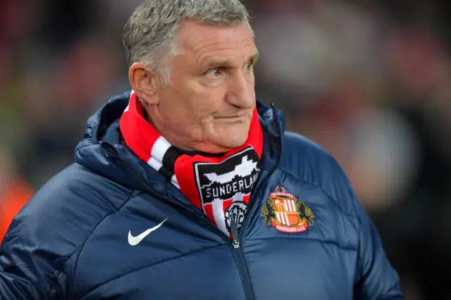 Tony Mowbray in a blue jacket with Sunderland's crest on it and a club scarf underneath.