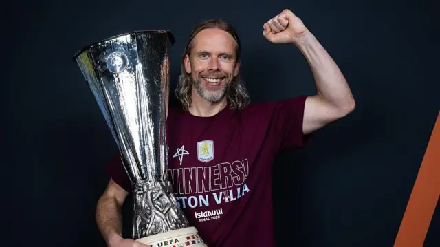 Austin MacPhee posing with the Europa League trophy