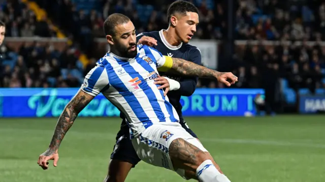 Kilmarnock's Kyle Vassell and Dundee's Ethan Ingram in action