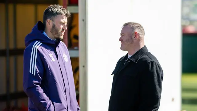 Wayne Rooney speaks with Michael Carrick at Carrington Training Ground 