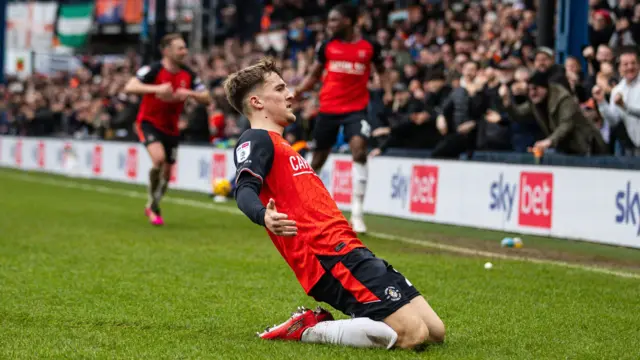 Jake Richards slides on his knees to celebrate his goal for Luton against Bradford City