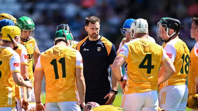 Neil McManus speaks with the Antrim players before last week's defeat by Galway