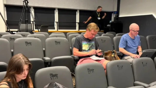 Journalists wait for an Ipswich news conference