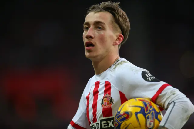 Jack Clarke holds a ball while in Sunderland home kit