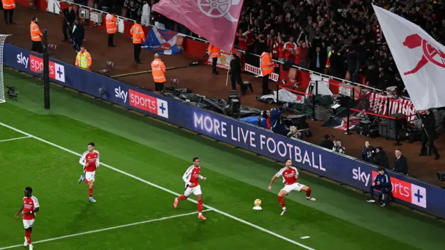 Mikel Merino celebrates a goal against Liverpool in front of Arsenal fans