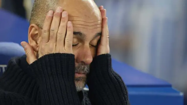 Pep Guardiola with his head in his hands