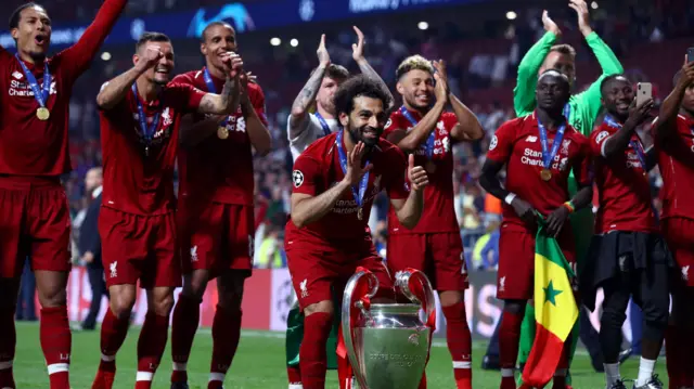 Mohamed Salah celebrates with the Champions League trophy