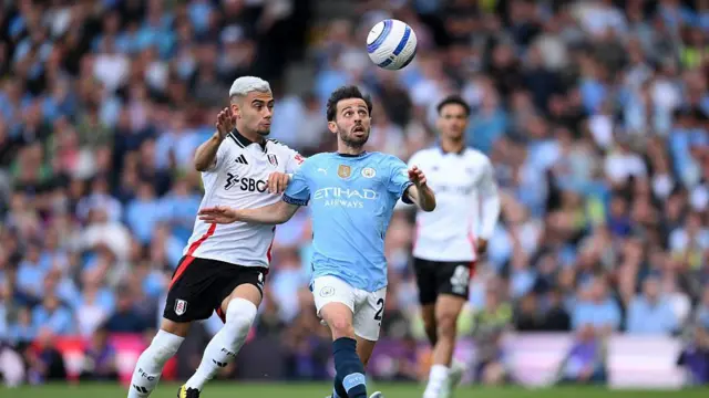Bernardo Silva of Manchester City is challenged by Andreas Pereira of Fulham