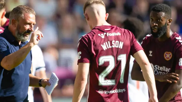 Heart of Midlothian Head Coach Derek McInnes (L) passes instruction onto goalscorer James Wilson during a Premier Sports Cup group stage match between Heart of Midlothian and Dunfermline at Tynecastle Park
