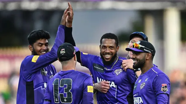 Chris Jordan (centre) celebrates a wicket with his Hobart Hurricanes team-mates