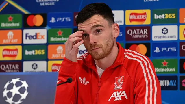 Andy Robertson looks on during news conference