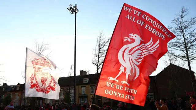 Liverpool fans with flags outside Anfield