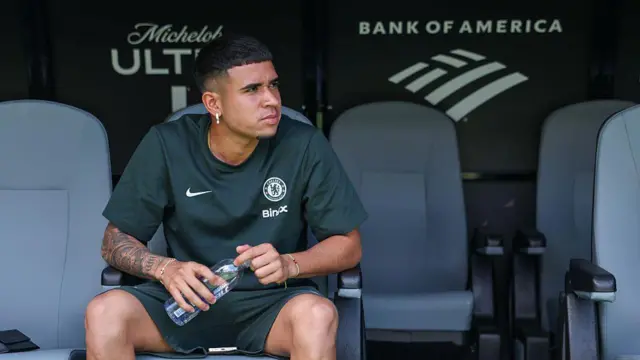 Chelsea midfielder Kendry Paez sits on the substitute bench in training wear