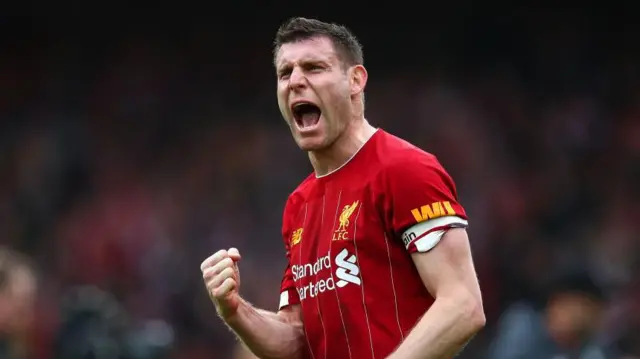 James Milner celebrates while playing for Liverpool.