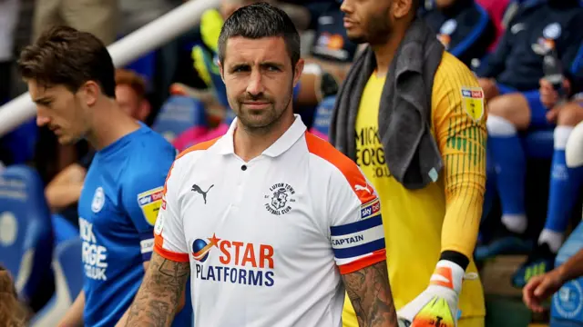 Alan Sheehan leads Luton out in 2018