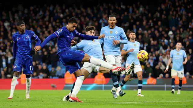 Levi Colwill of Chelsea shoots whilst under pressure from Josko Gvardiol of Manchester City