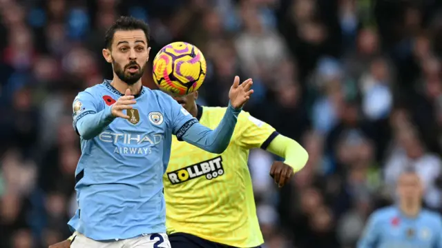 Manchester City's Portuguese midfielder #20 Bernardo Silva (L) vies for the ball against Southampton's English defender #02 Kyle Walker-Peters (back) during the English Premier League football match between Manchester City and Southampton at the Etihad Stadium