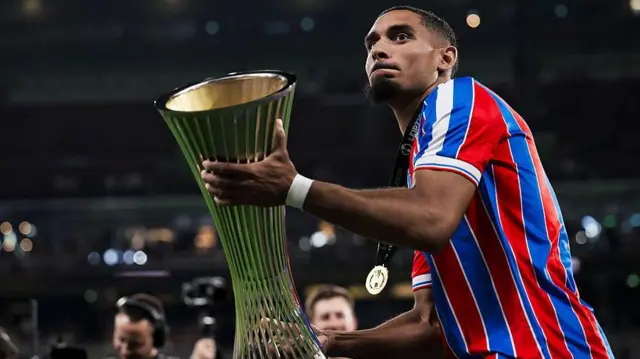 Maxence Lacroix of Crystal Palace lifts the Conference League trophy