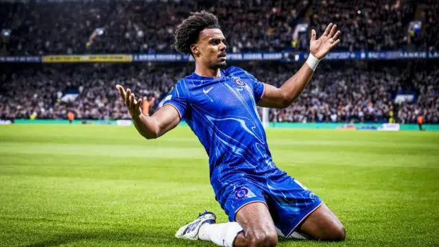 Renato Veiga slides on his knees to celebrate scoring for Chelsea against Genk