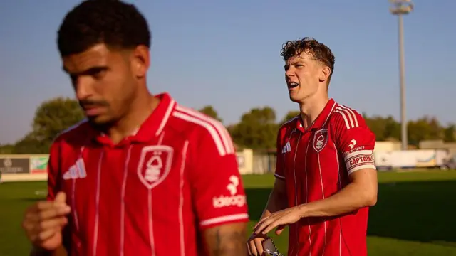 Ryan Yates walks off a pitch wearing a captain's armband. Morgan Gibbs-White walks off in front of him