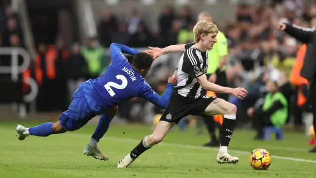 Anthony Gordon of Newcastle United is fouled by James Justin of Leicester City during the Premier League match between Newcastle United FC and Leicester City FC at St James' Park