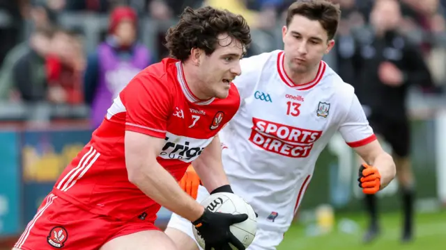 Cork's Chris Og Jones tracks Derry's Padraig McGrogan 