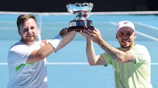 Andy Lapthorne (right) and Dutchman Sam Schroder celebrate winning the quad wheelchair doubles at the Australian Open.
