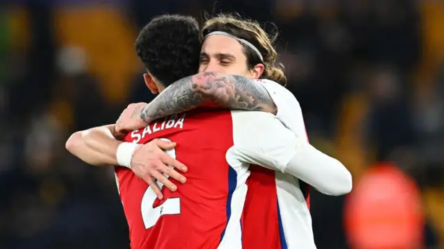 Riccardo Calafiori of Arsenal celebrates victory with William Saliba