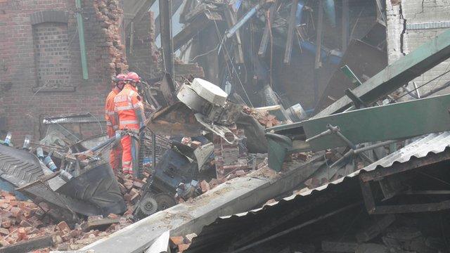 Rescue workers in the rubble